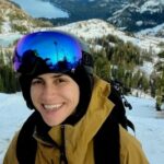Lee Morris, Co Founder of Challenge Accepted, stops to smile during a snowboarding trip